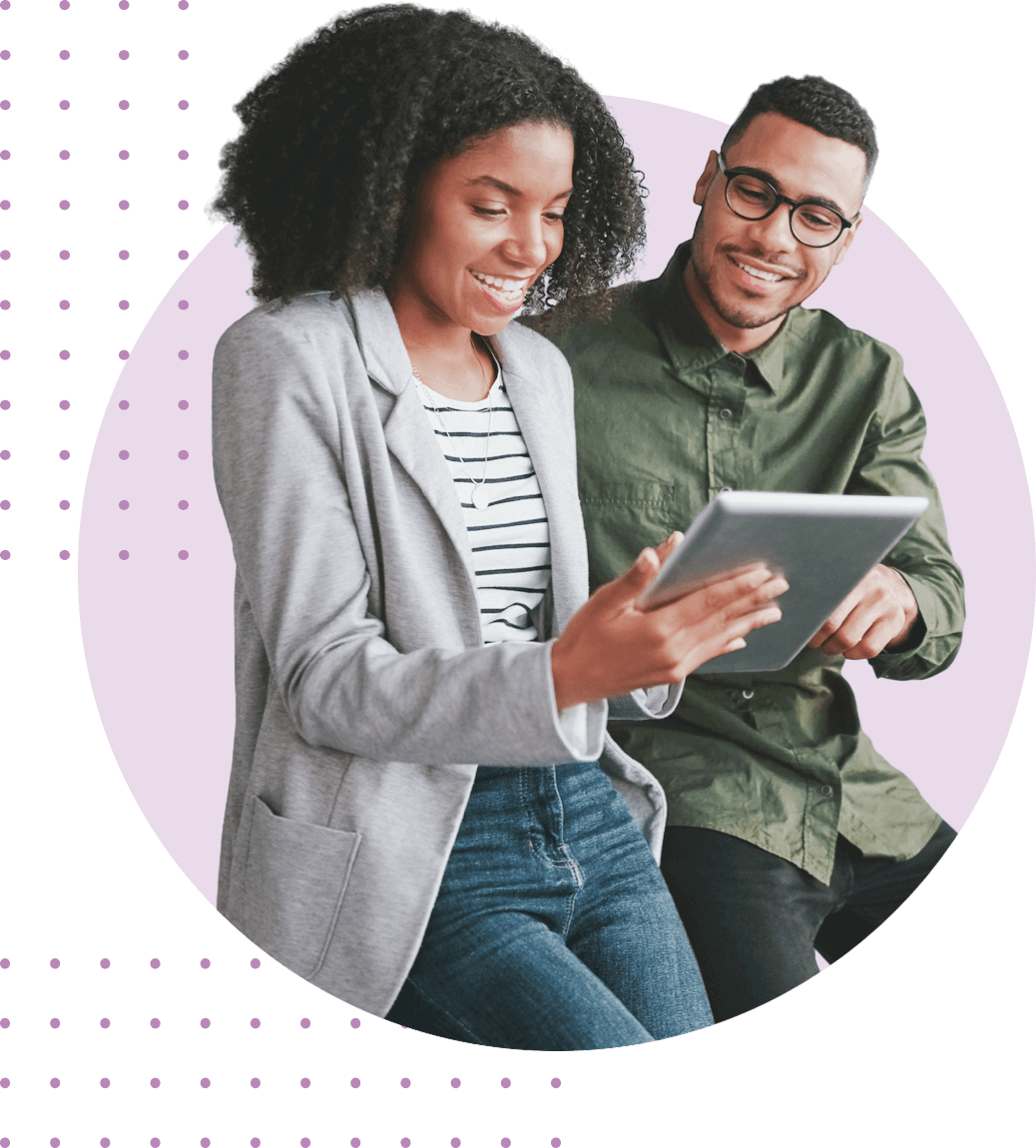 A man and a woman looking at a tablet together